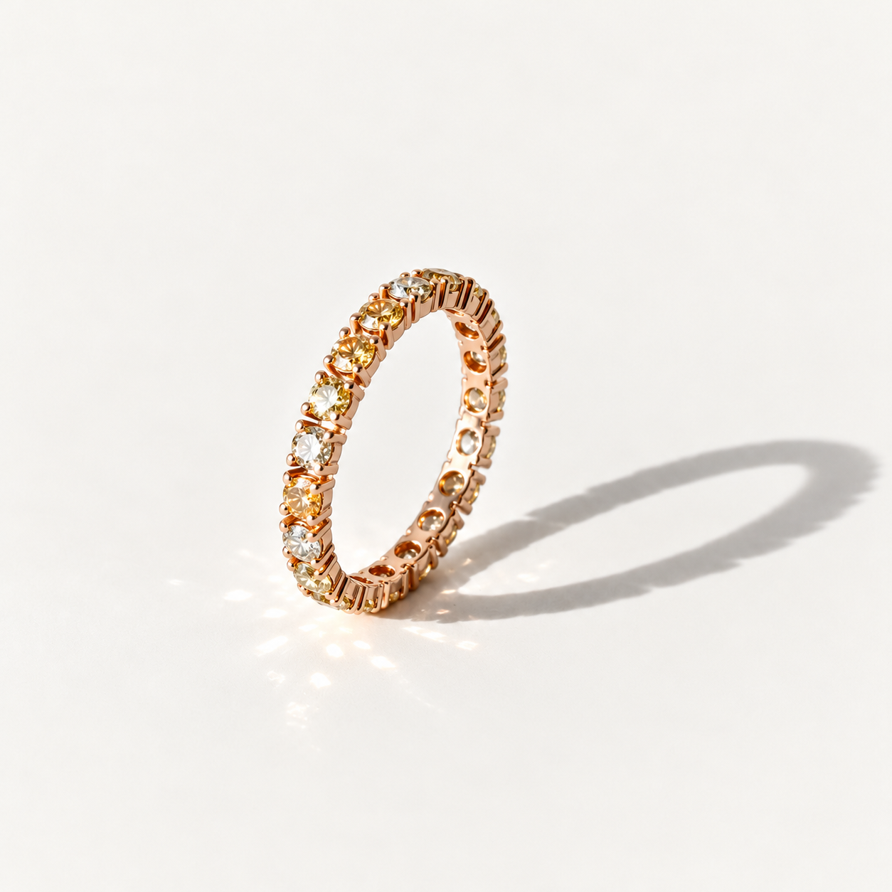 Champagne diamond eternity ring in 14k rose gold, shown upright with pale yellow, champagne, gold diamonds and natural white reflections.