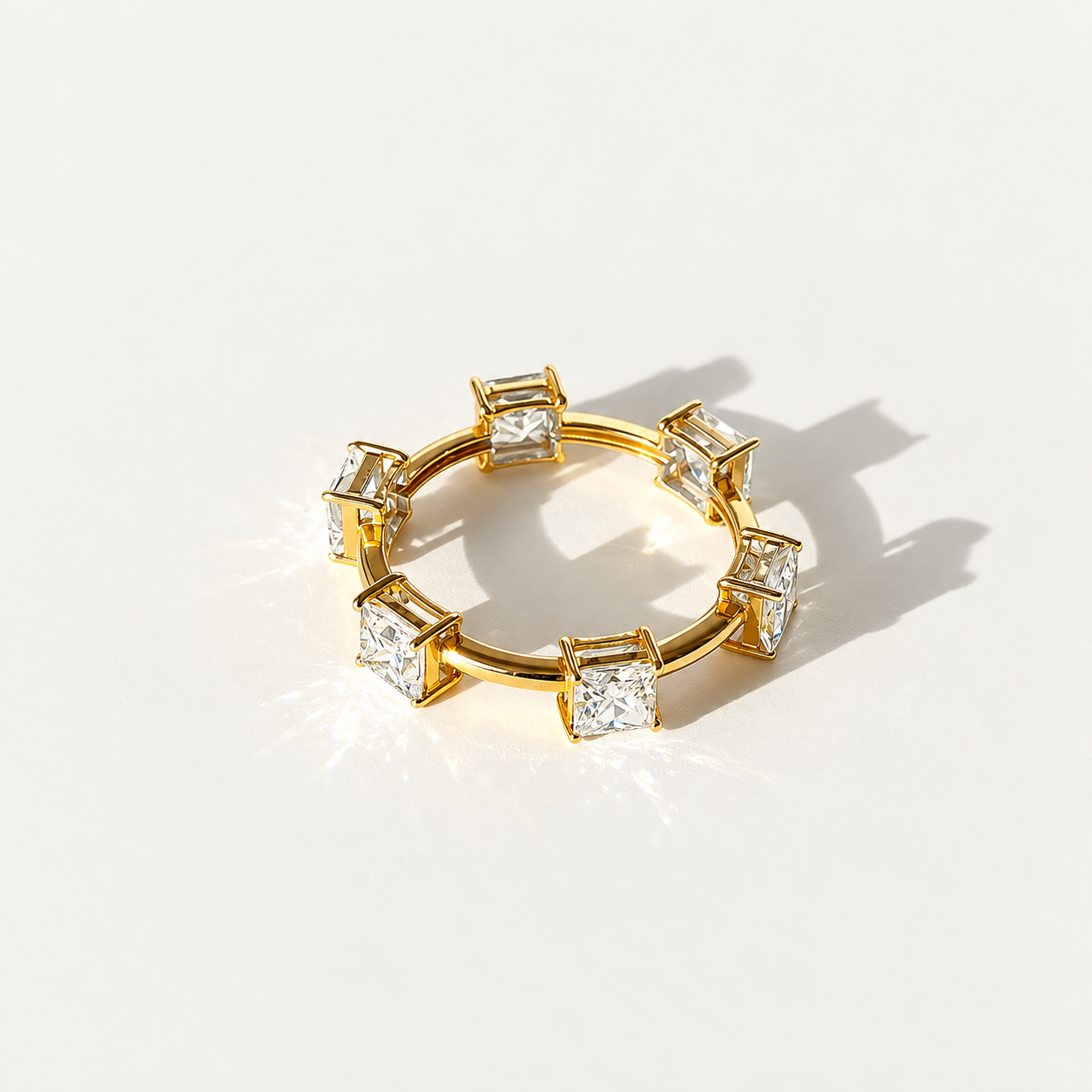 Eterling eternity ring in 14k yellow gold with six spaced princess-cut lab-grown diamonds.