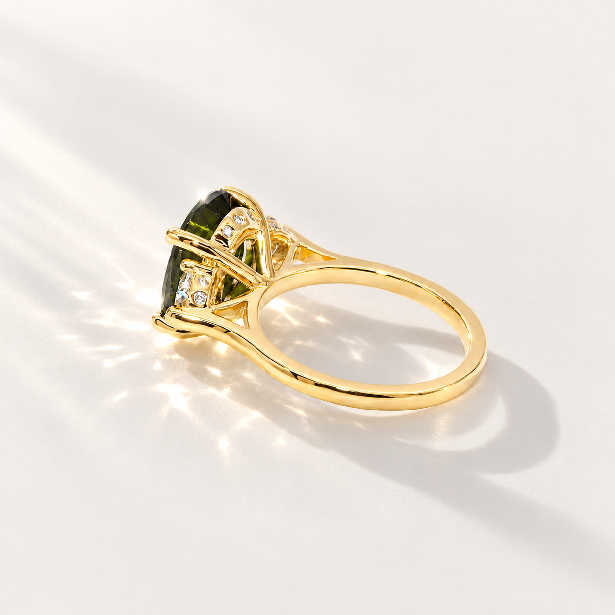 Maeve handmade 14k yellow gold ring with a 4.45ct oval green tourmaline, two half-moon lab-grown diamonds and small diamond accents.