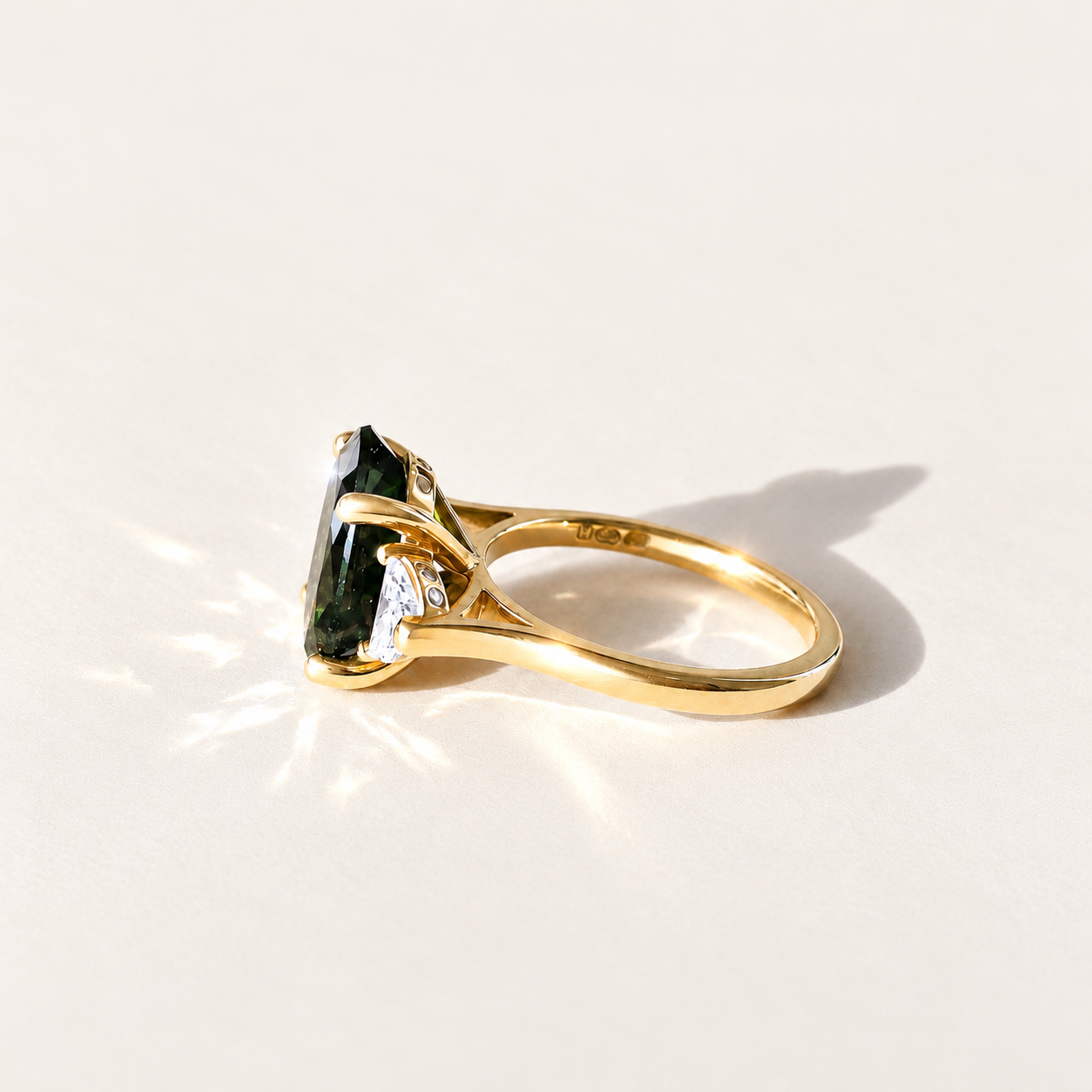 Maeve handmade 14k yellow gold ring with a 4.45ct oval green tourmaline, two half-moon lab-grown diamonds and small diamond accents.