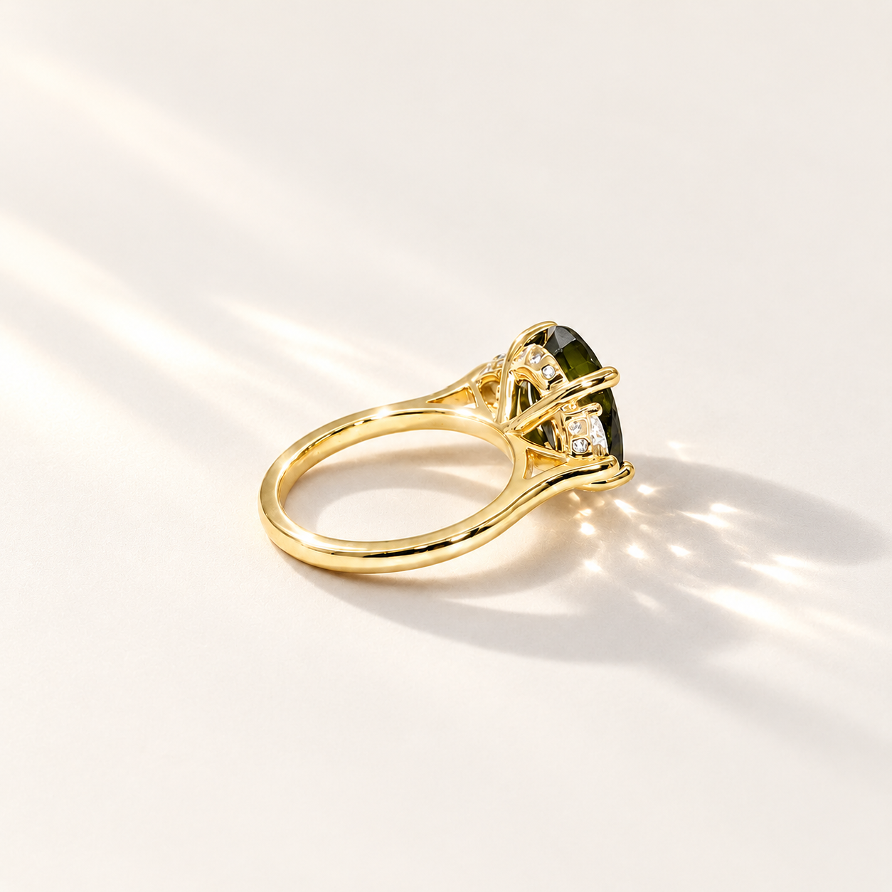 Maeve handmade 14k yellow gold ring with a 4.45ct oval green tourmaline, two half-moon lab-grown diamonds and small diamond accents.