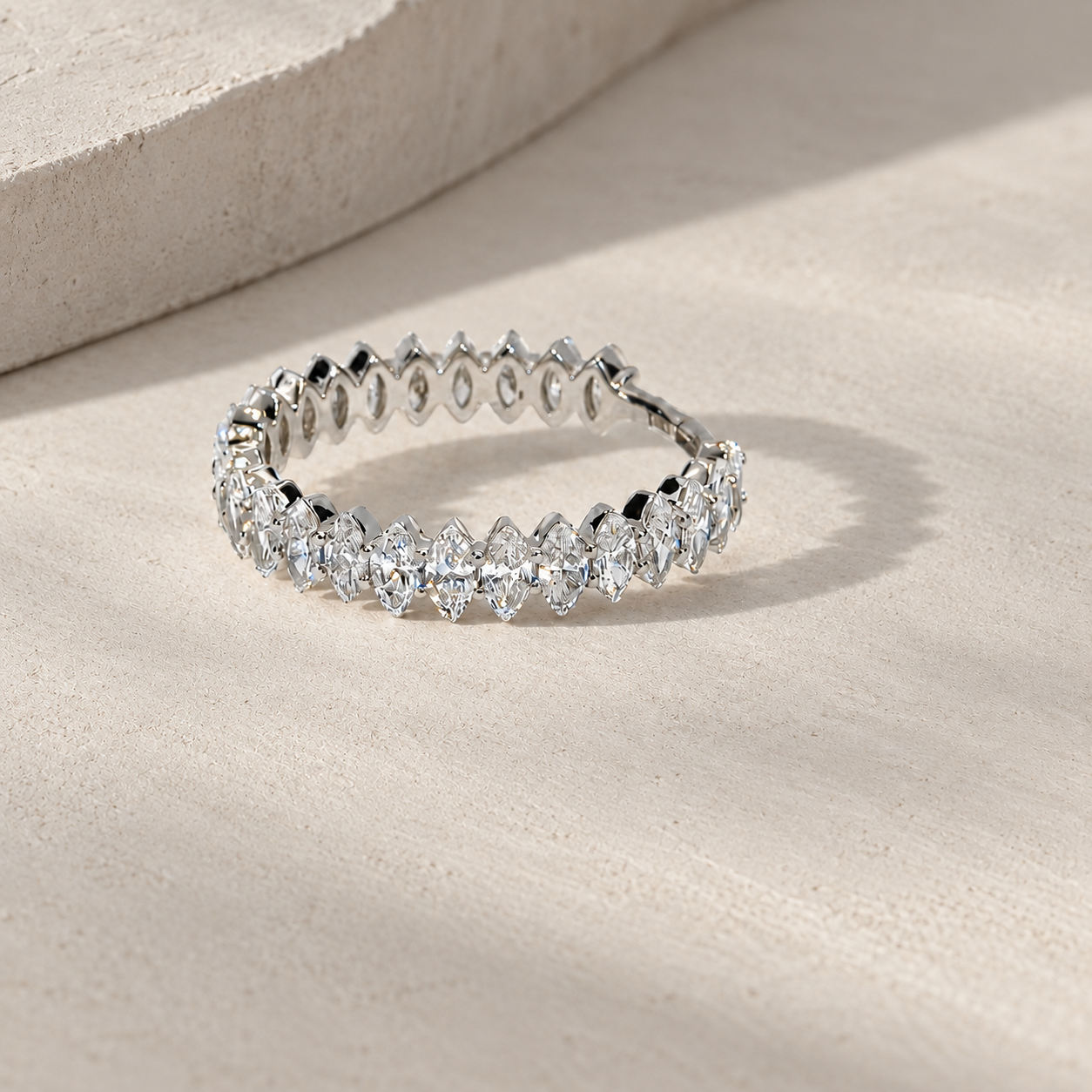 marquise diamond half eternity band in 14K white gold, set with lab-grown diamonds, photographed on a light grey-beige background with natural shadows.